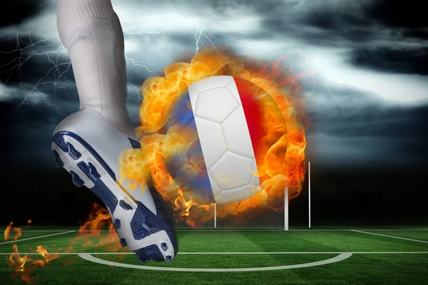 Football player kicking flaming france flag ball — Stock Photo, Image