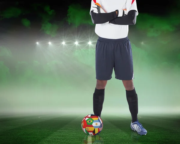 Composite image of goalkeeper standing with international ball — Stock Photo, Image