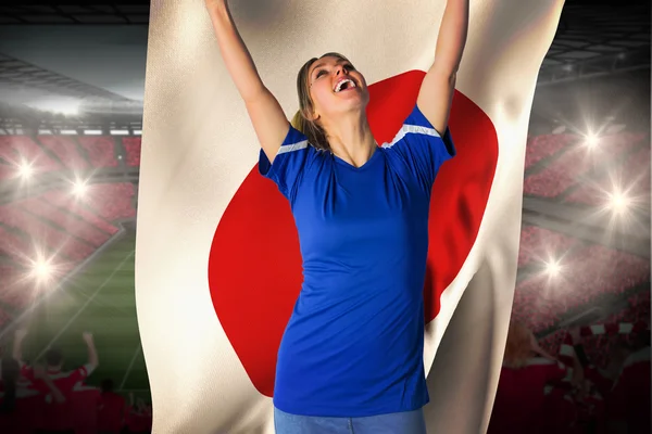 Cheering football fan in blue jersey holding  flag — Stock Photo, Image