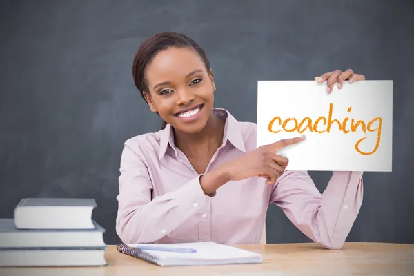 Happy teacher holding page showing coaching — Stock Photo, Image