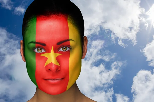 Composite image of beautiful brunette in cameroon facepaint — Stock Photo, Image