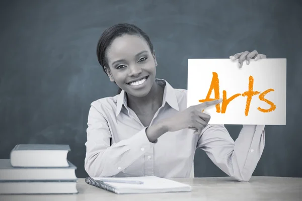 Happy teacher holding page showing arts — Stock Photo, Image