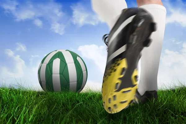 Football boot kicking nigeria ball — Stock Photo, Image