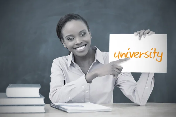 Happy teacher holding page showing university — Stock Photo, Image