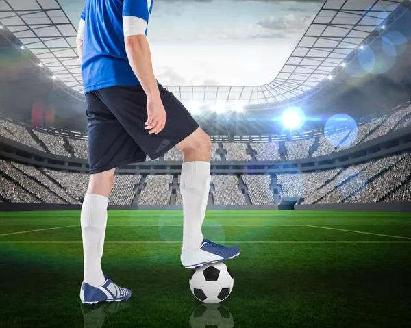 Composite image of football player standing with ball — Stock Photo, Image