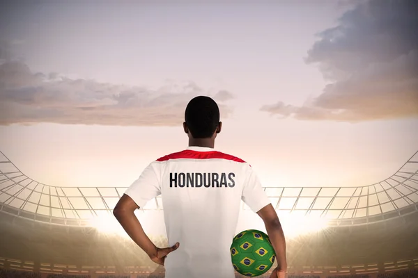 Композитное изображение гондурасского футболиста, держащего мяч — стоковое фото