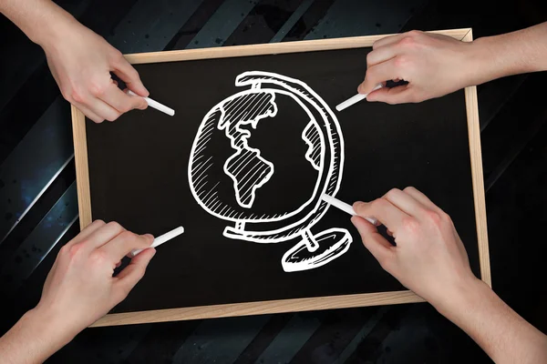 Multiple hands drawing globe with chalk