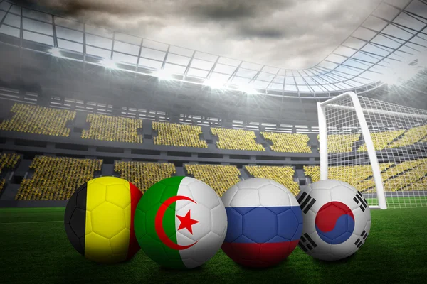 Composite image of footballs in group h colours for world cup — Stock Photo, Image