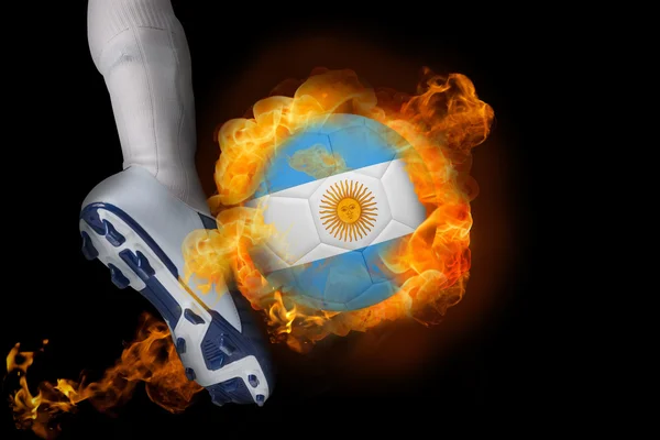 Football player kicking flaming argentina flag ball — Stock Photo, Image