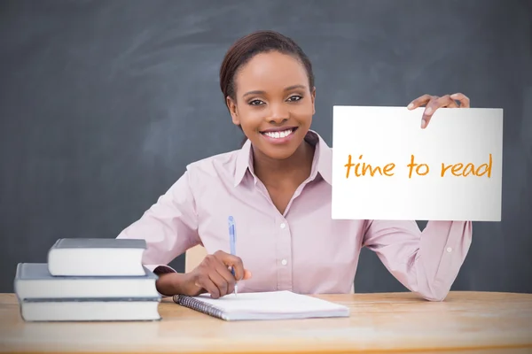 Happy teacher holding page showing time to read — Stock Photo, Image