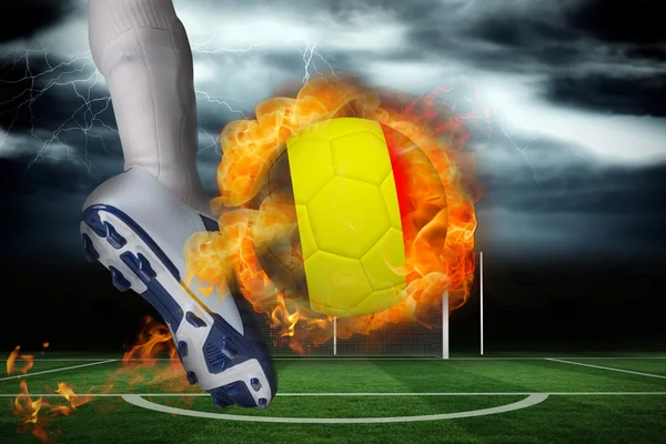 Football player kicking flaming belgium flag ball — Stock Photo, Image