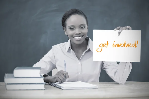 Happy teacher holding page showing get involved — Stock Photo, Image