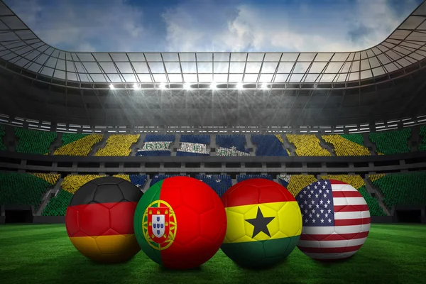 Composite image of footballs in group g colours for world cup — Stock Photo, Image