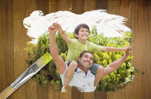 Composite image of father and son in the park — Stock Photo, Image