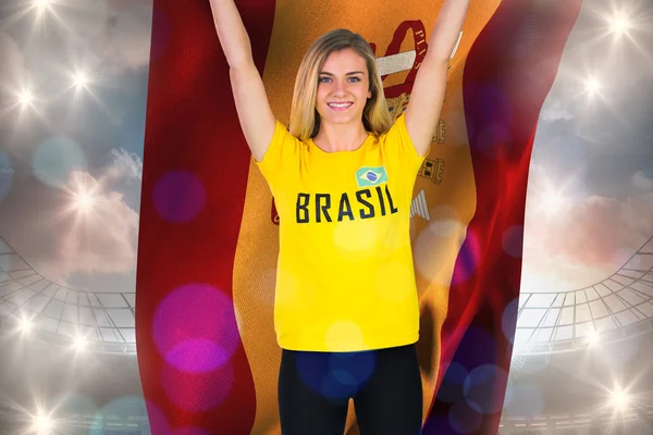 Excited football fan in brasil tshirt holding — Stock Photo, Image