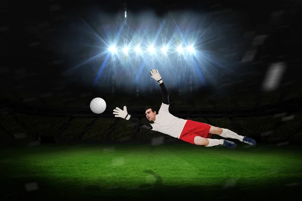 Composite image of goalkeeper in white making a save — Stock Photo, Image