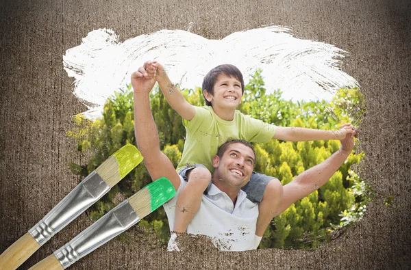 Composite image of father and son in the park — Stock Photo, Image