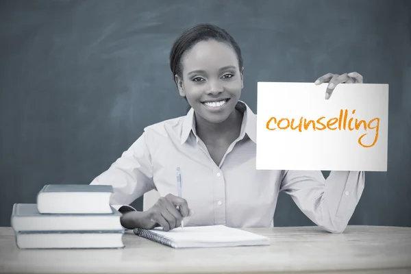 Happy teacher holding page showing counselling — Stock Photo, Image