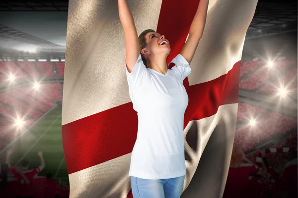 Pretty football fan in white cheering holding  flag