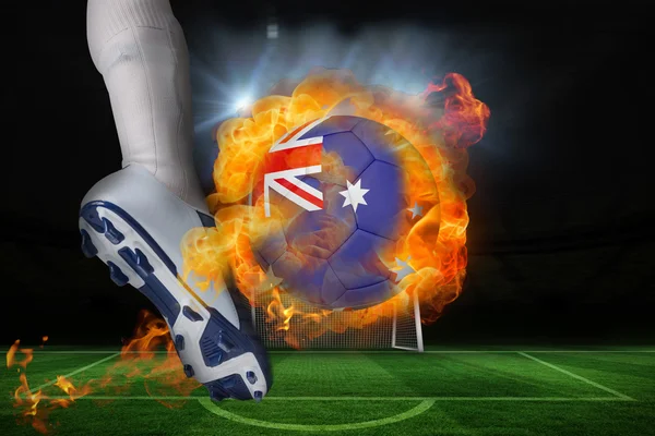 Football player kicking flaming australia flag ball — Stock Photo, Image