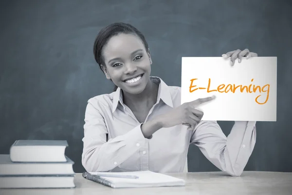 Happy teacher holding page showing e learning — Stock Photo, Image