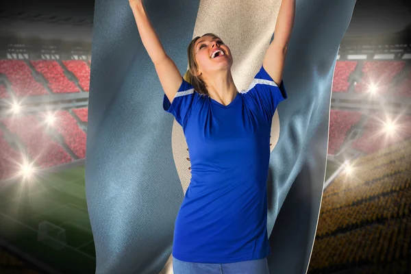 Cheering football fan in blue jersey holding  flag — Stock Photo, Image