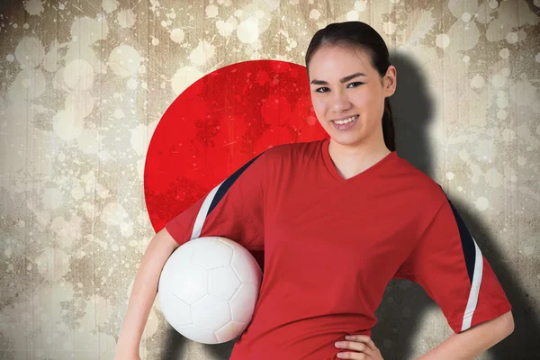 Composite image of smiling asian football fan looking at camera — Stock Photo, Image