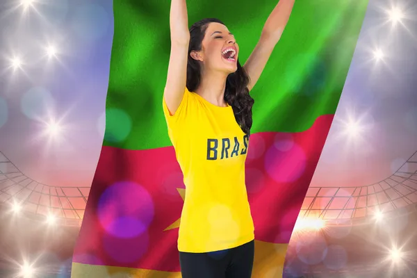 Excited football fan in brasil tshirt holding flag — Stock Photo, Image