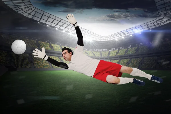Composite image of goalkeeper in white making a save — Stock Photo, Image