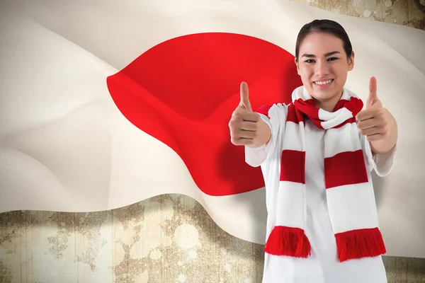 Football fan in white wearing scarf showing thumbs up — Stock Photo, Image
