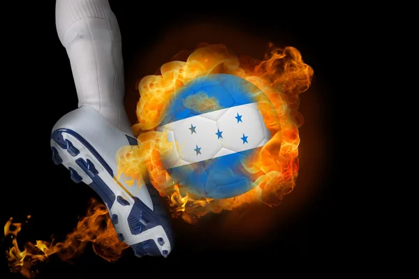 Football player kicking flaming honduras flag ball — Stock Photo, Image