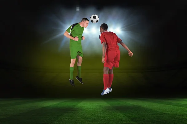 Composite image of football players tackling for the ball — Stock Photo, Image