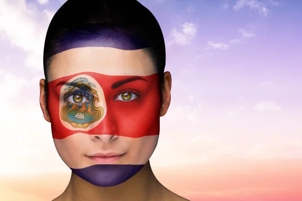 Sammansatt bild av vacker brunett i costa rica facepaint — Stockfoto