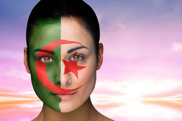 Composite image of beautiful brunette in algeria facepaint — Stock Photo, Image