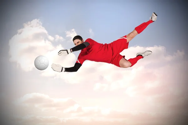 Composite image of fit goal keeper jumping up — Stock Photo, Image