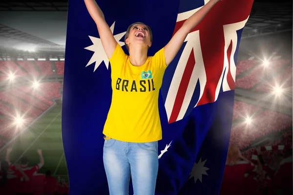 Excited football fan in brasil tshirt holding flag — Stock Photo, Image