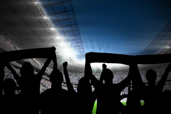 Silhouettes of football supporters