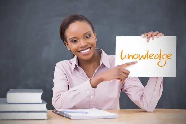 Happy teacher holding page showing knowledge — Stock Photo, Image