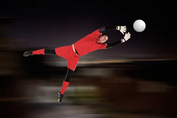 Composite image of fit goal keeper jumping up — Stock Photo, Image