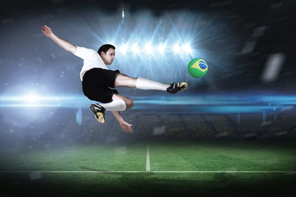 Composite image of football player in white kicking — Stock Photo, Image