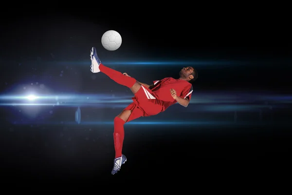 复合图像的红色踢的足球运动员 — 图库照片