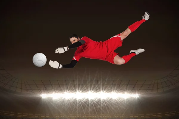 Composite image of fit goal keeper jumping up — Stock Photo, Image