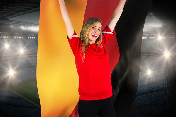 Composite image of cheering football fan in red holding germany — Stock Photo, Image