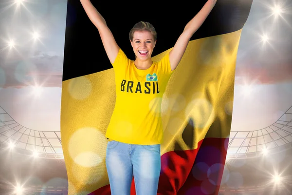 Excited football fan in brasil tshirt holding — Stock Photo, Image