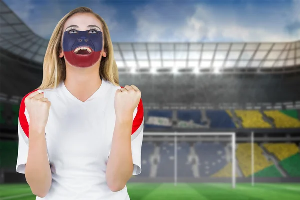 Composite image of excited russia fan in face paint cheering — Stock Photo, Image