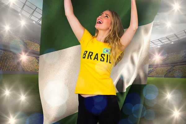 Excited football fan in brasil tshirt holding — Stock Photo, Image