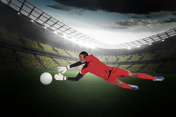 Composite image of goalkeeper in red making a save — Stock Photo, Image