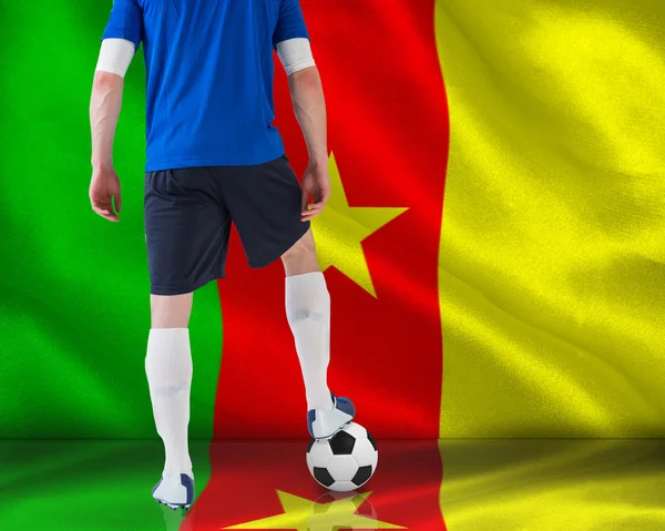 Composite image of football player standing with ball — Stock Photo, Image