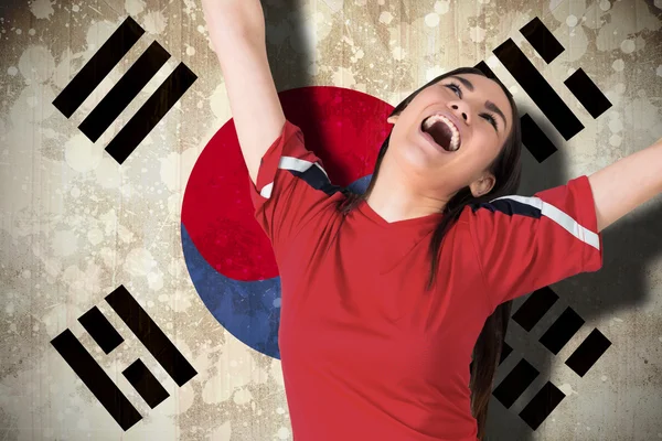 Composite image of excited asian football fan cheering — Stock Photo, Image