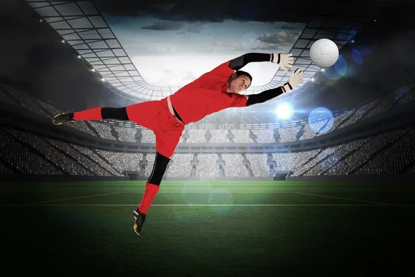 Composite image of fit goal keeper jumping up — Stock Photo, Image